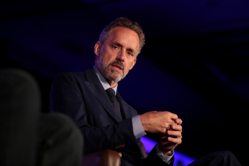 Clinical psychologist Jordan Peterson sitting in an armchair. Photo taken from below.