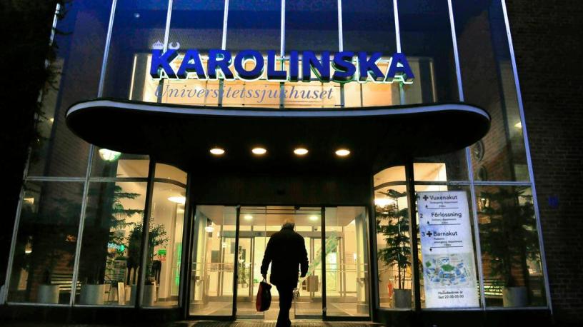 A man walks into the entrance of the Karolinska University Hospital in Stockholm.