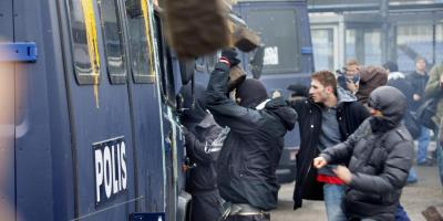 Rioters attack a police picket truck in Malmö, Sweden.